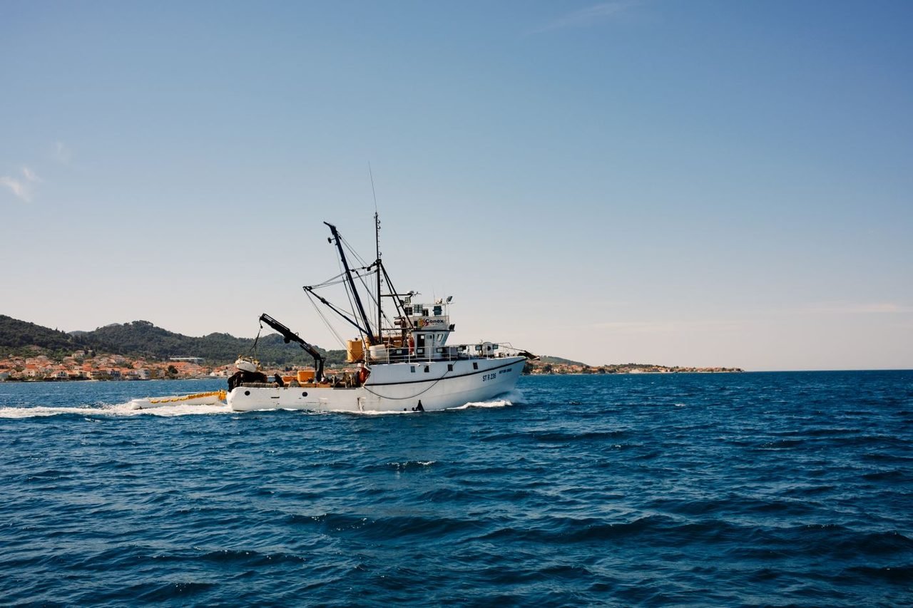 A white fishing trawler under way at sea