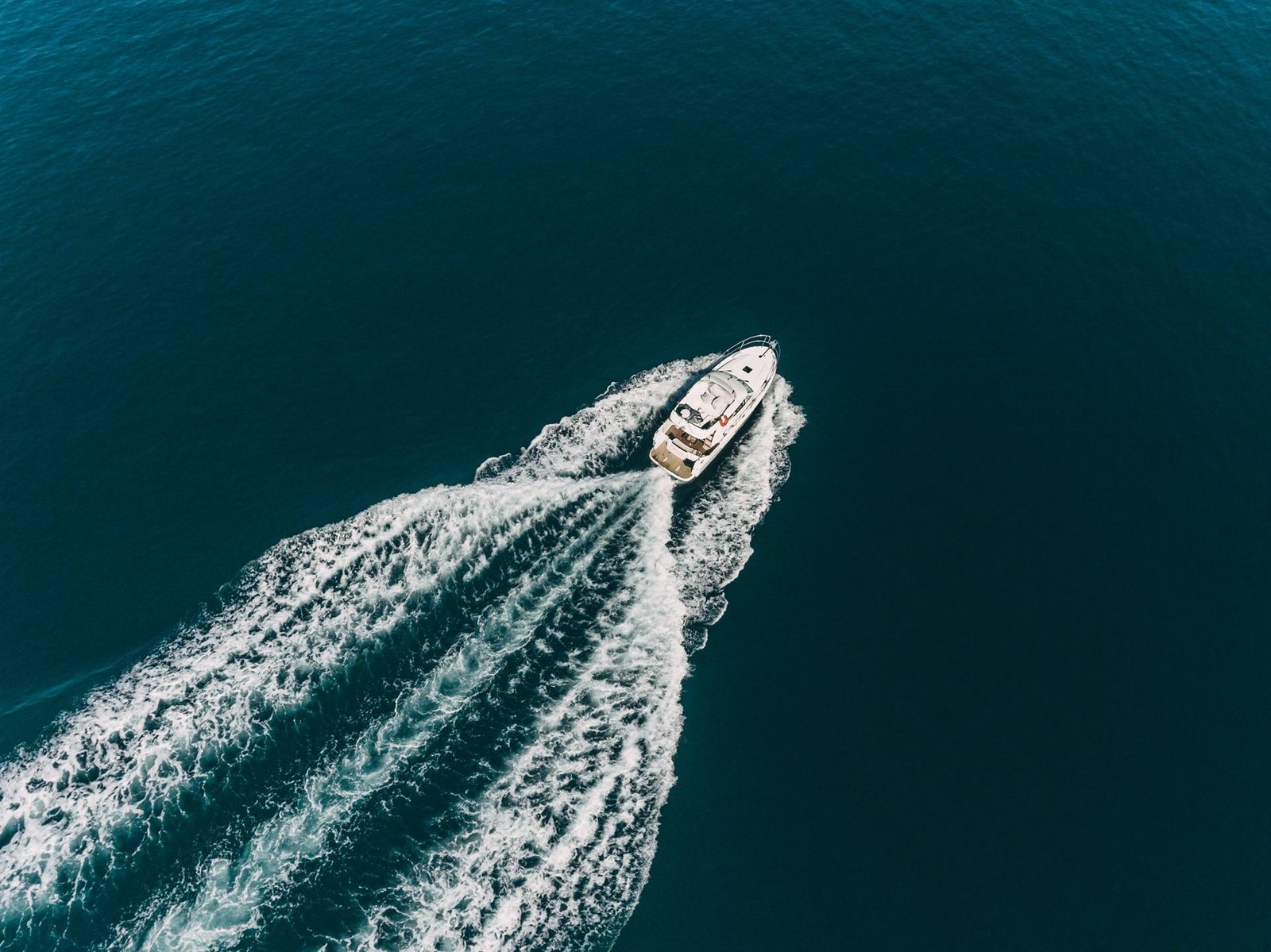 Aerial view of a motor yacht cruising across open water