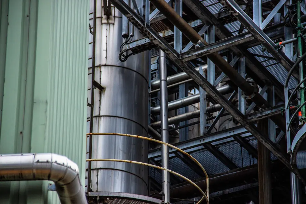 Close-up of industrial pipework and steel walkways
